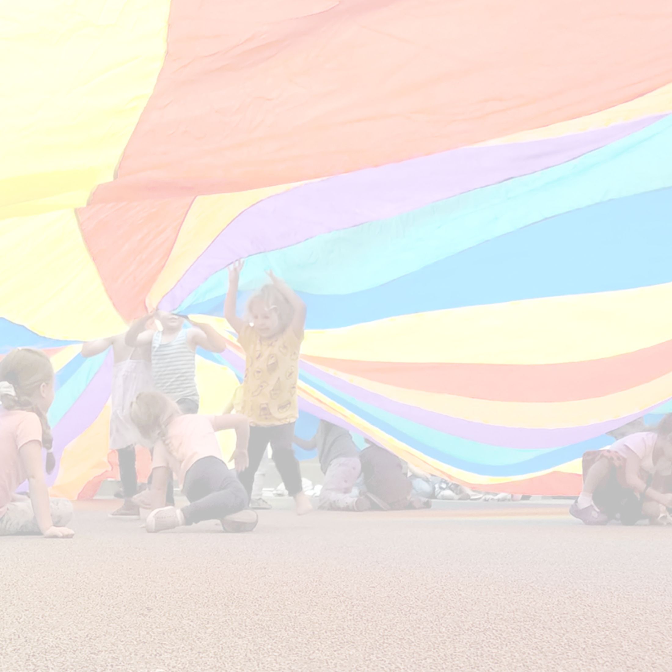 kids under a rainbow parachute