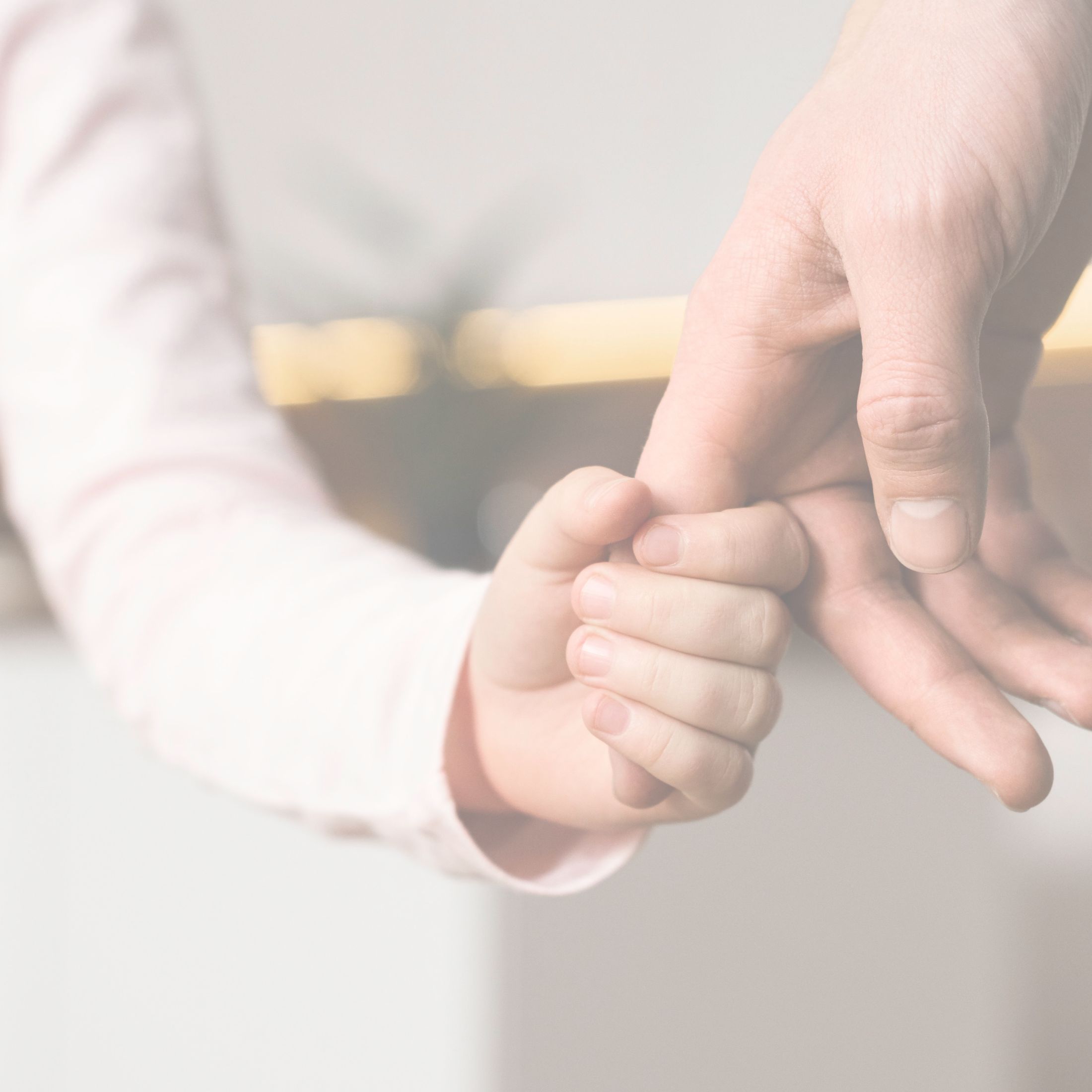 child holding parent's hand