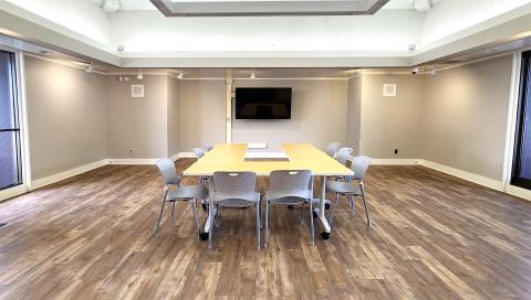 tables and chairs boardroom-style in room