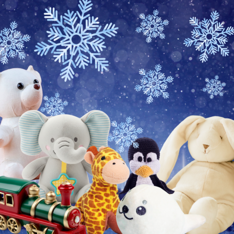 Stuffed animals and a train in front of a background of falling snowflakes
