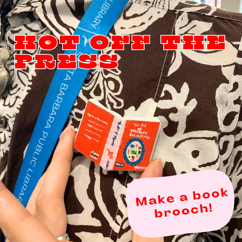 blue lanyard and a book-shaped brooch 